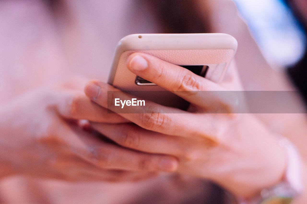 Midsection of woman using mobile phone 