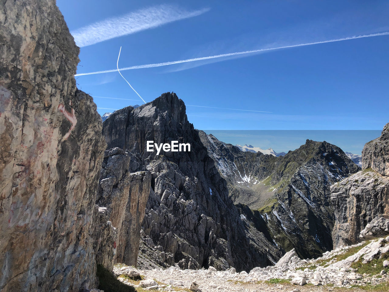 Scenic view of mountains against blue sky