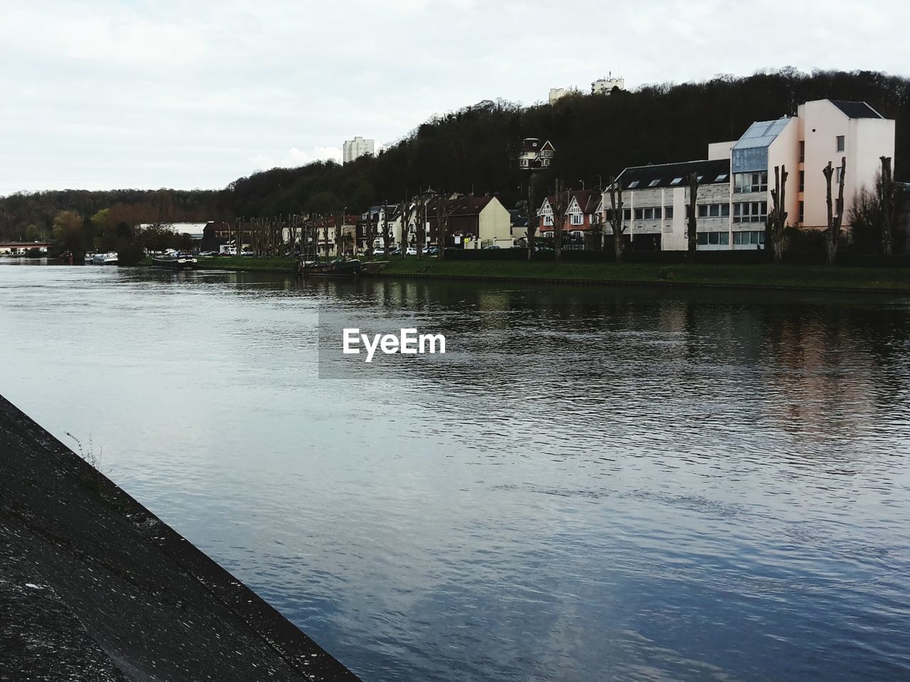 RIVER WITH HOUSES IN BACKGROUND