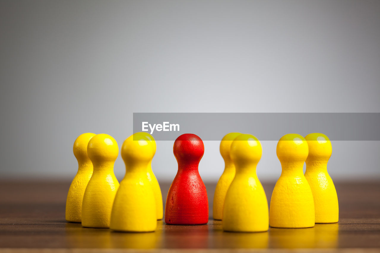 Close-up of tokens on table against gray background