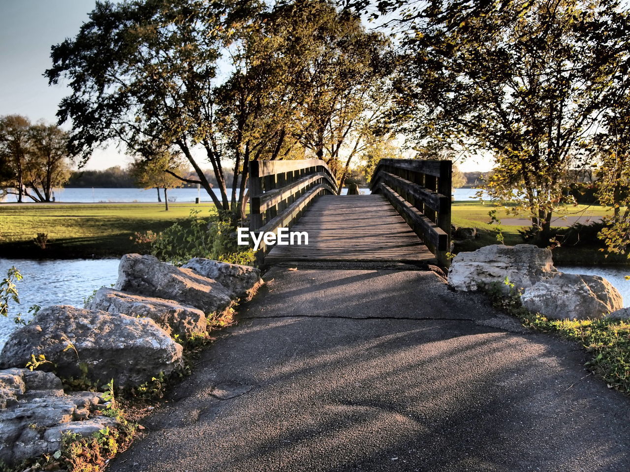 Footbridge over canal along trees