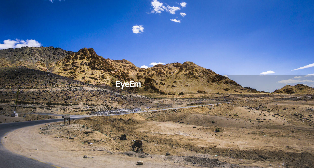 SCENIC VIEW OF MOUNTAINS AGAINST BLUE SKY