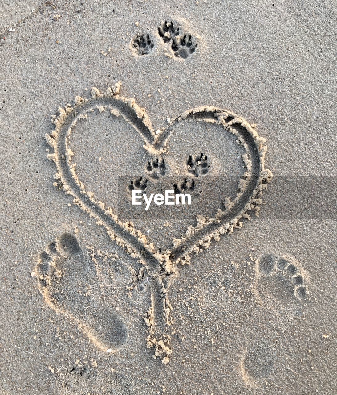 Close-up of heart shape on sand