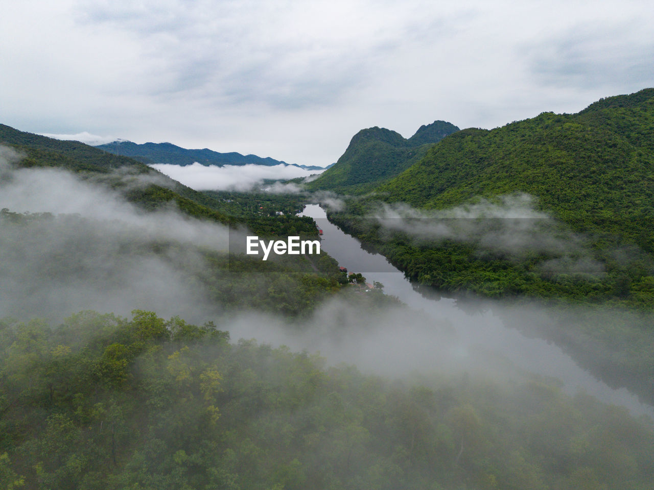 scenic view of mountains against cloudy sky