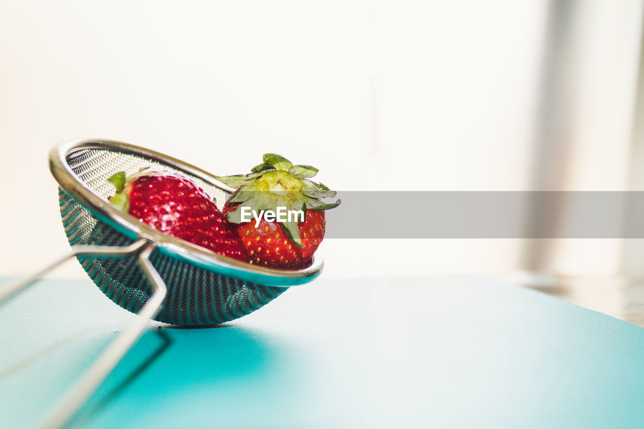 CLOSE-UP OF STRAWBERRIES IN BOWL