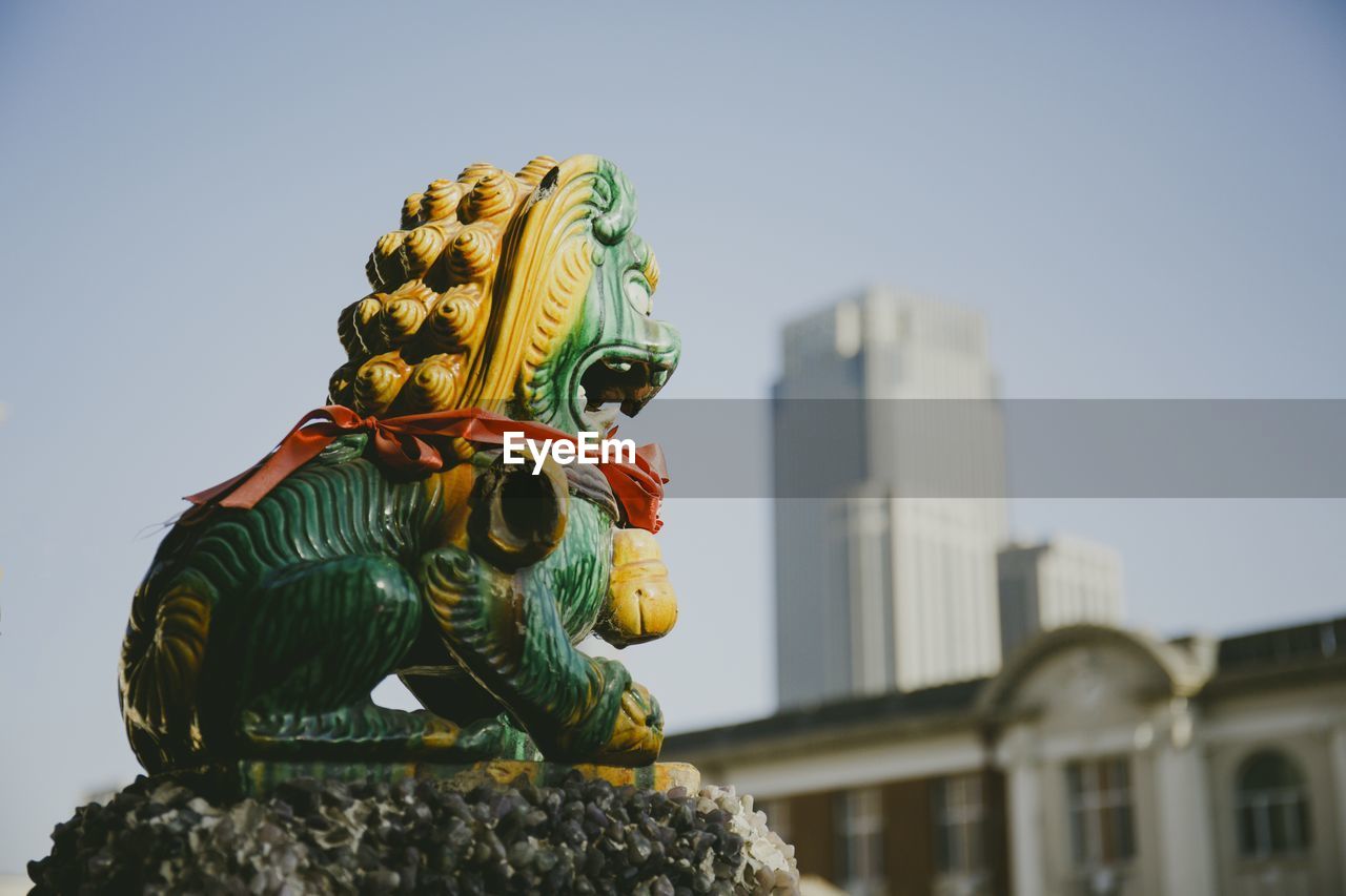 Low angle view of statue against sky