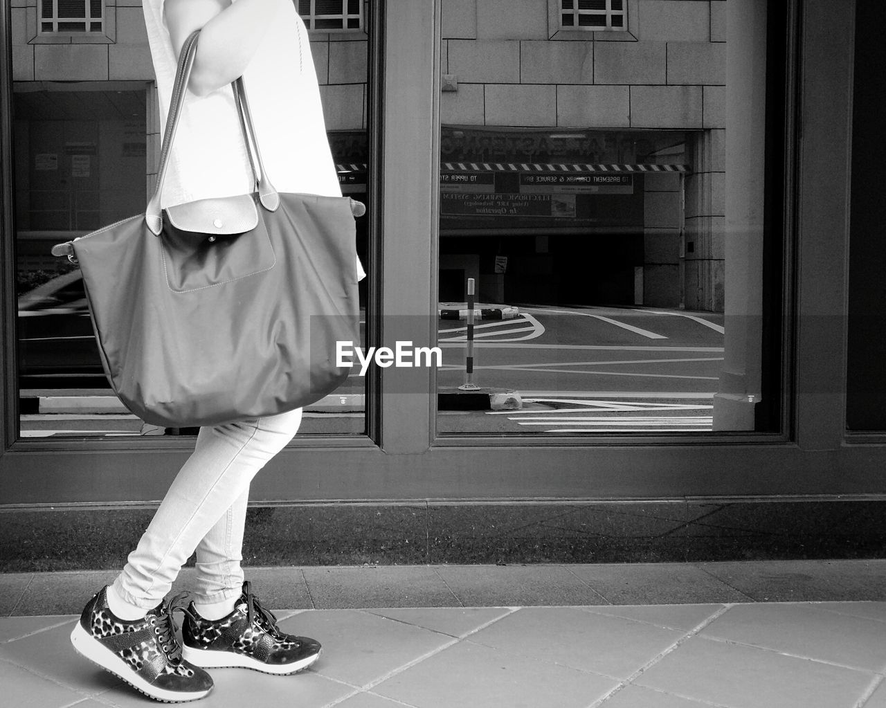 Side view of woman walking with handbag