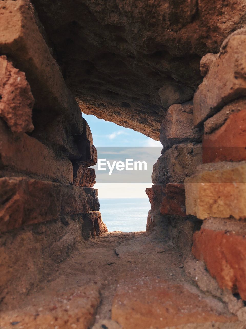 Rock formation on beach against sky