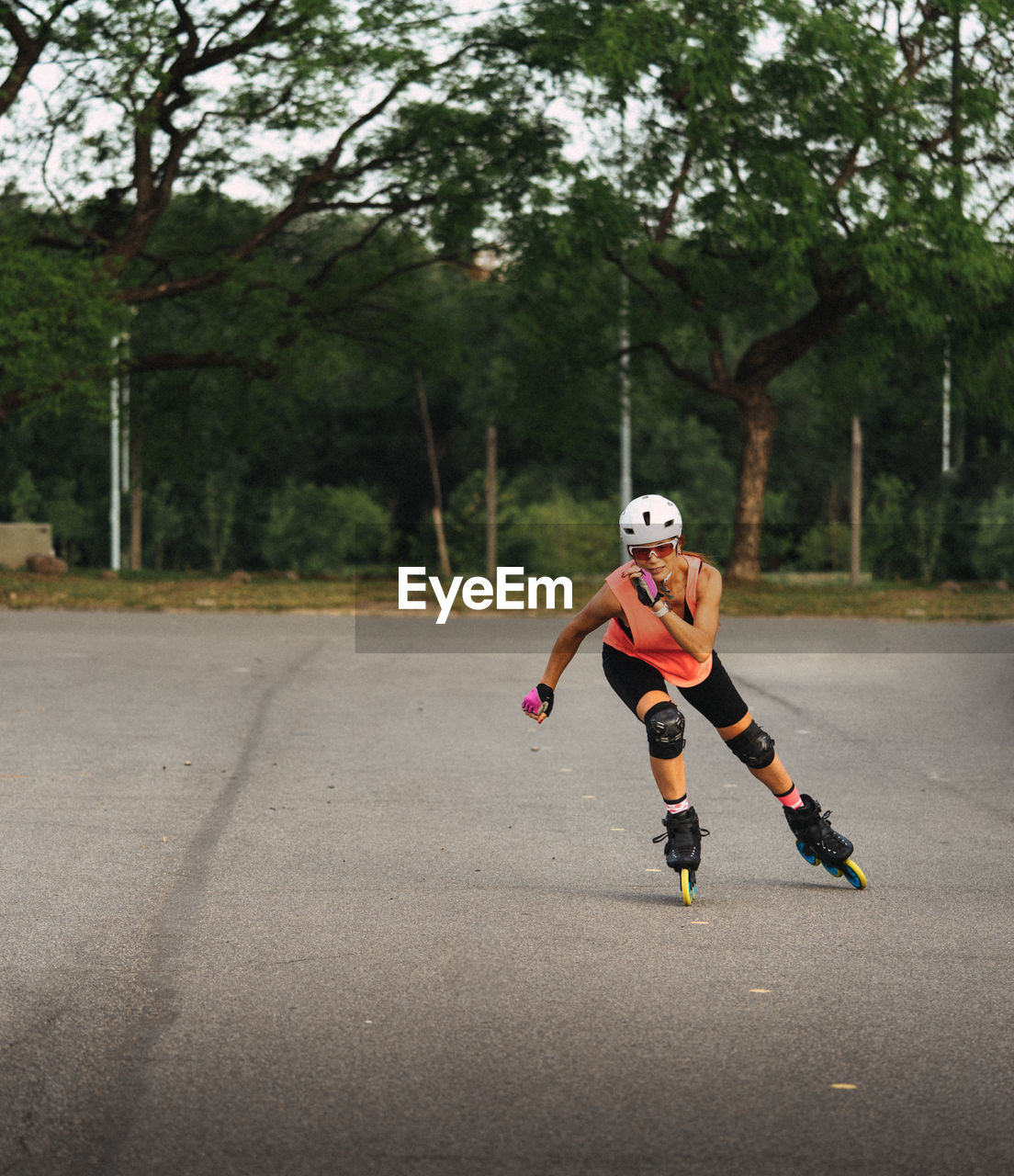 Full length of woman inline skating on road