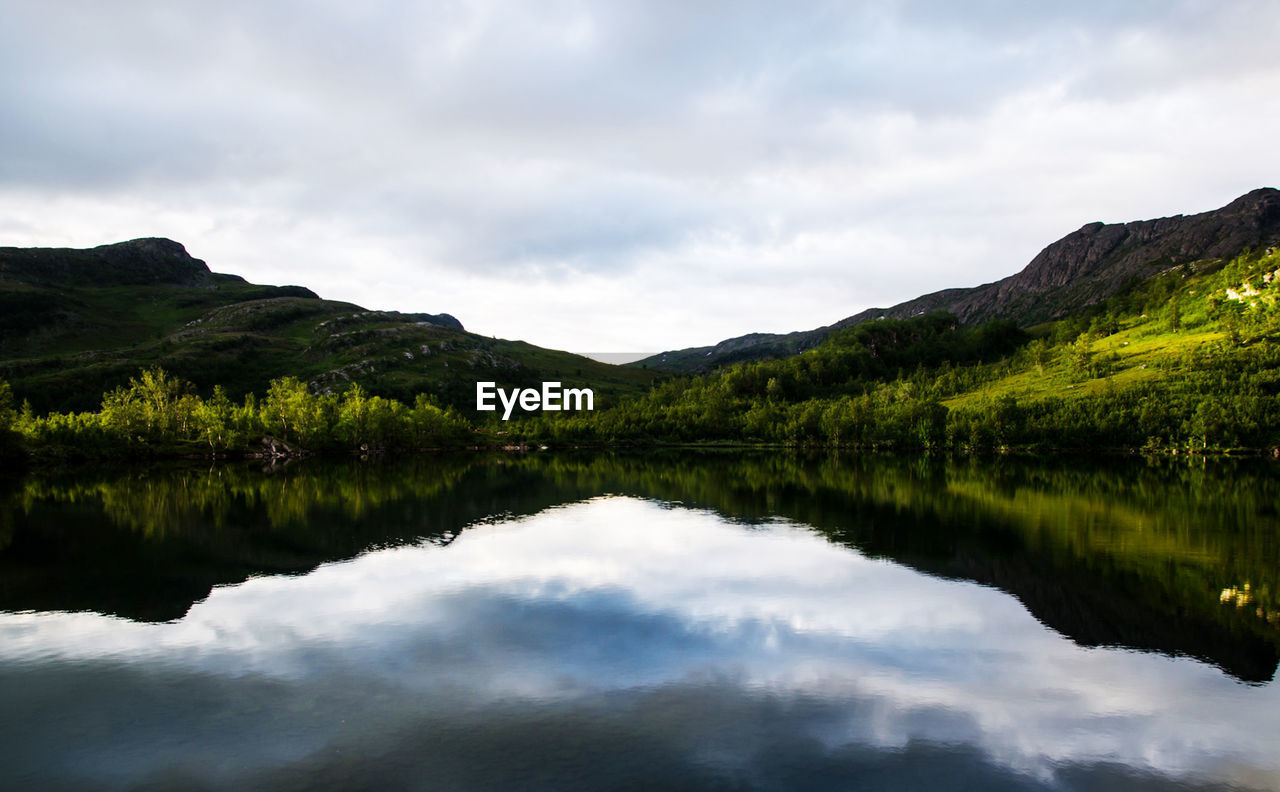 nature, reflection, water, sky, scenics - nature, lake, mountain, environment, beauty in nature, cloud, landscape, highland, tranquility, forest, tree, body of water, land, tranquil scene, plant, no people, wilderness, non-urban scene, travel destinations, mountain range, reservoir, overcast, travel, idyllic, outdoors, tourism, morning, fog, dramatic sky, trip, holiday, reflection lake, activity, green, woodland, vacation