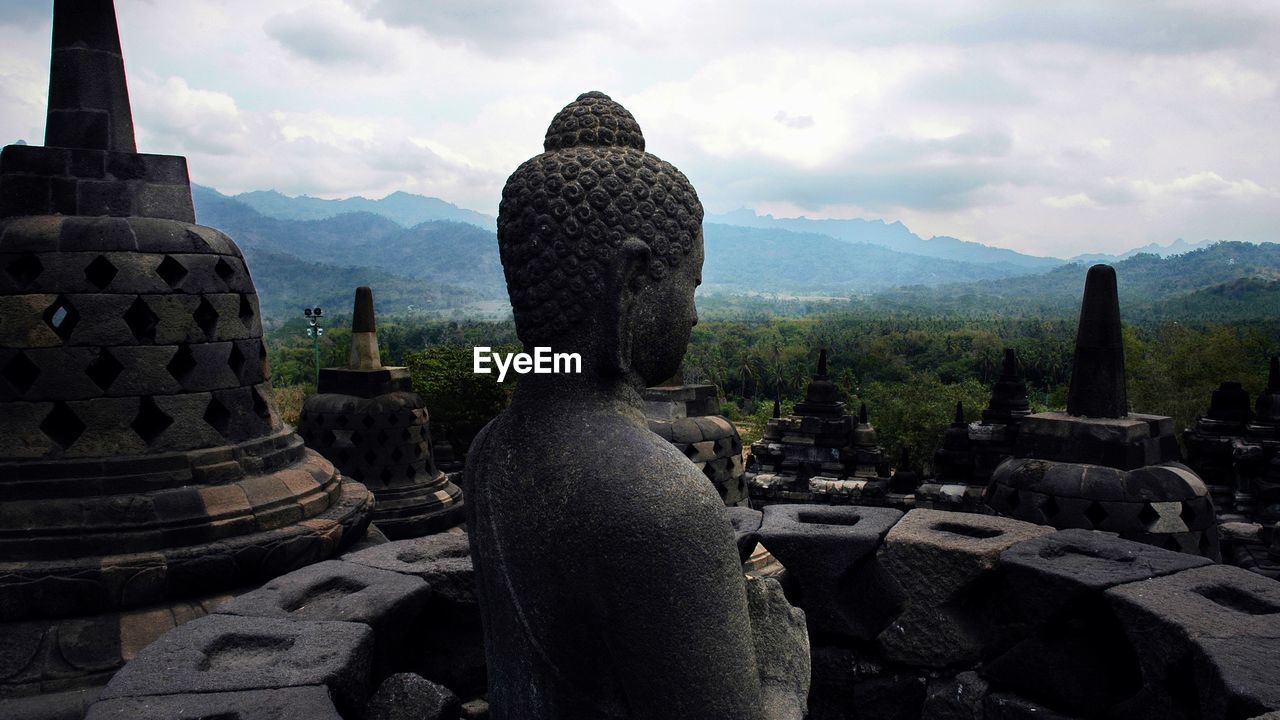 Ruins of temple against cloudy sky