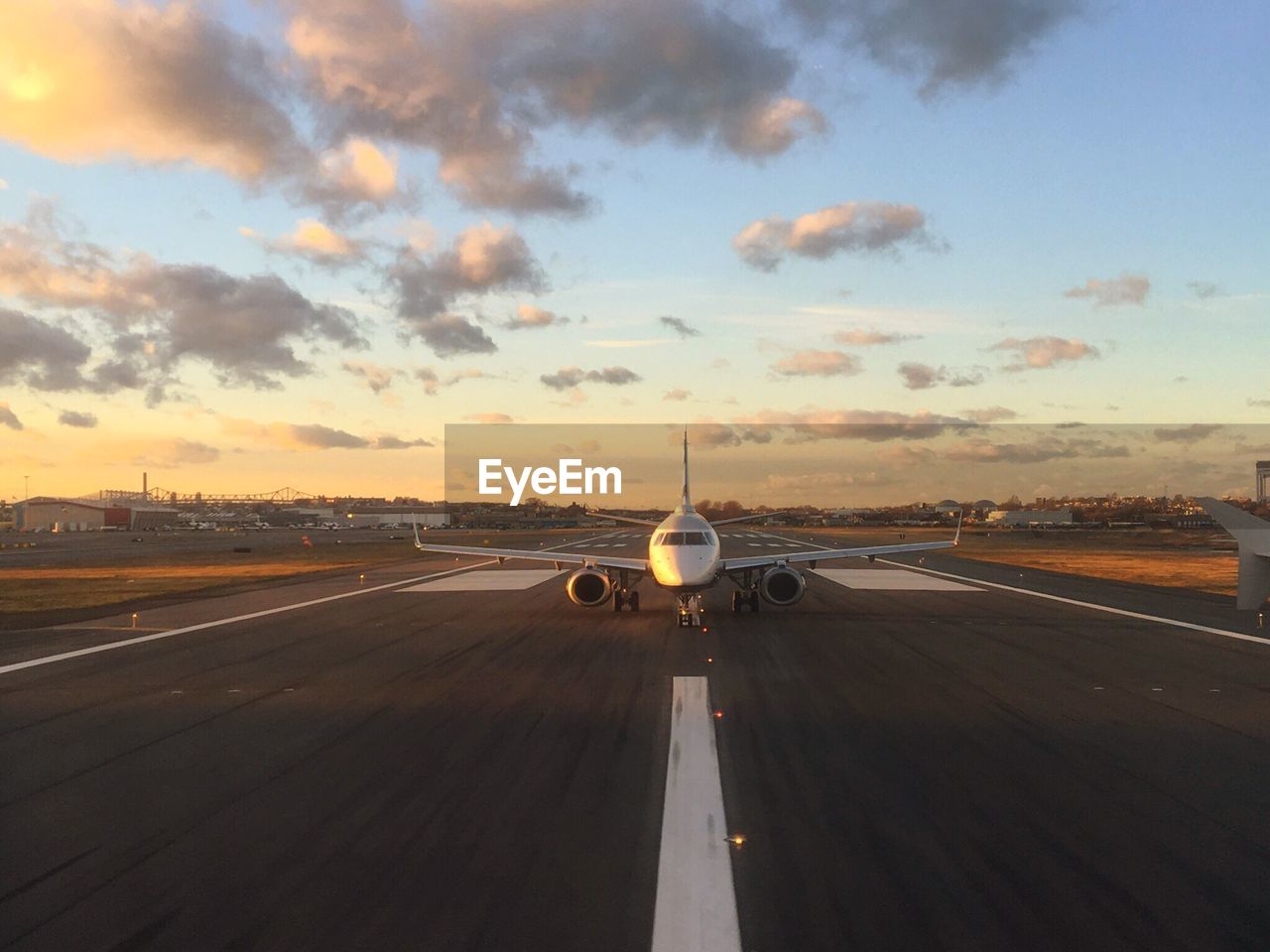 AIRPLANE ON RUNWAY AGAINST SKY