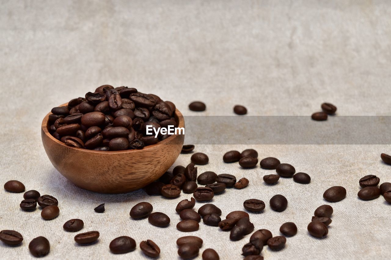 Roasted coffee beans in a wooden bowl