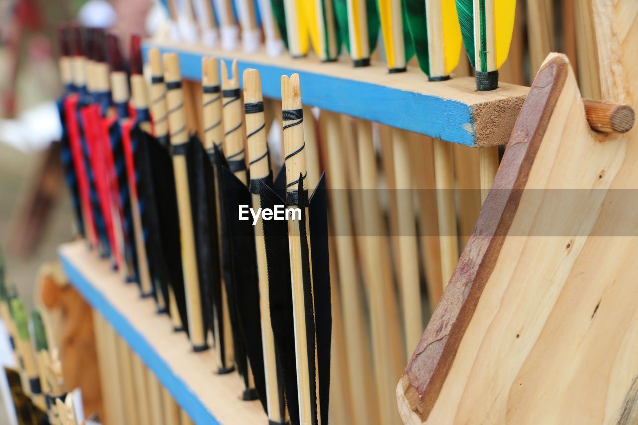 Close-up of multi colored traditional archery arrows in store