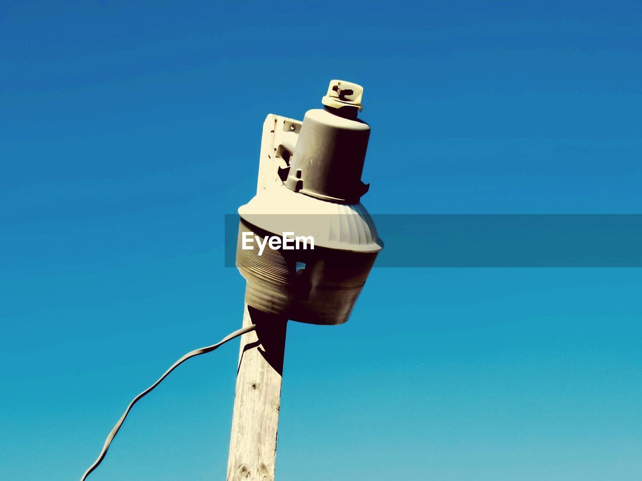 Low angle view of ferris wheel against clear blue sky