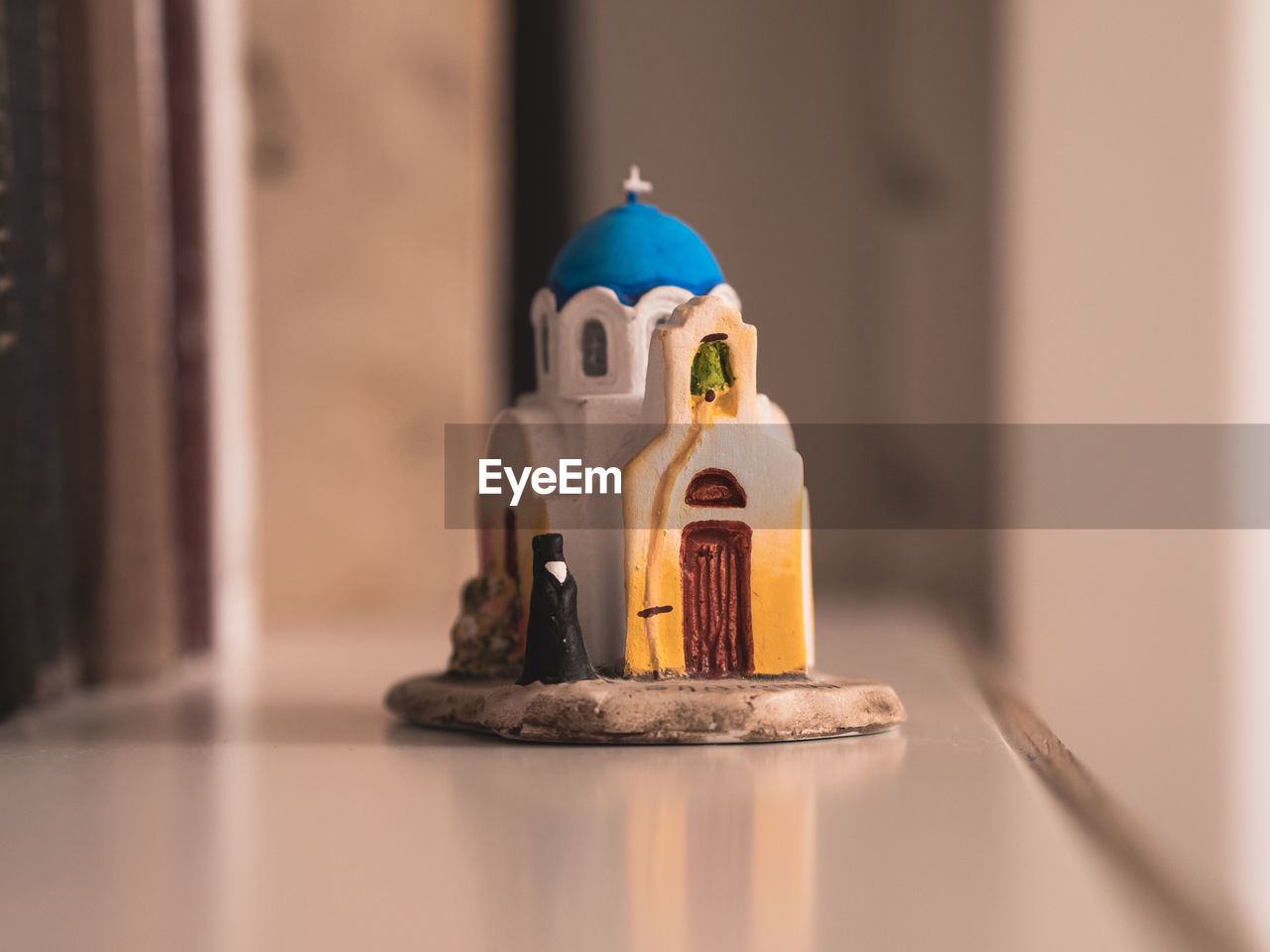 toy, no people, human representation, figurine, cartoon, representation, indoors, focus on foreground, religion