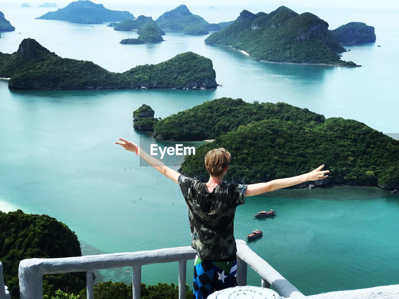 High angle view of man standing at observation point against sea