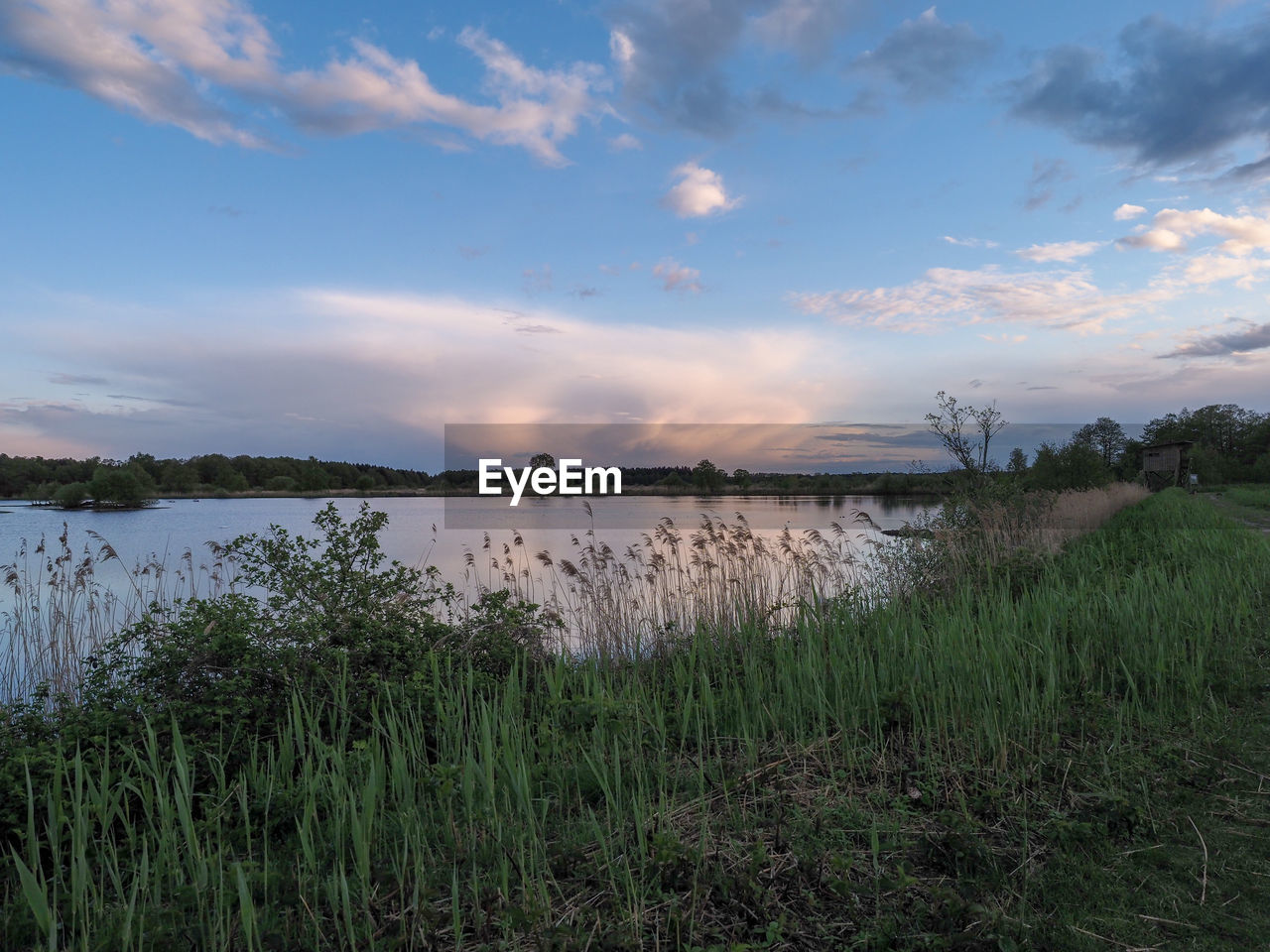 SCENIC VIEW OF LAKE AT SUNSET