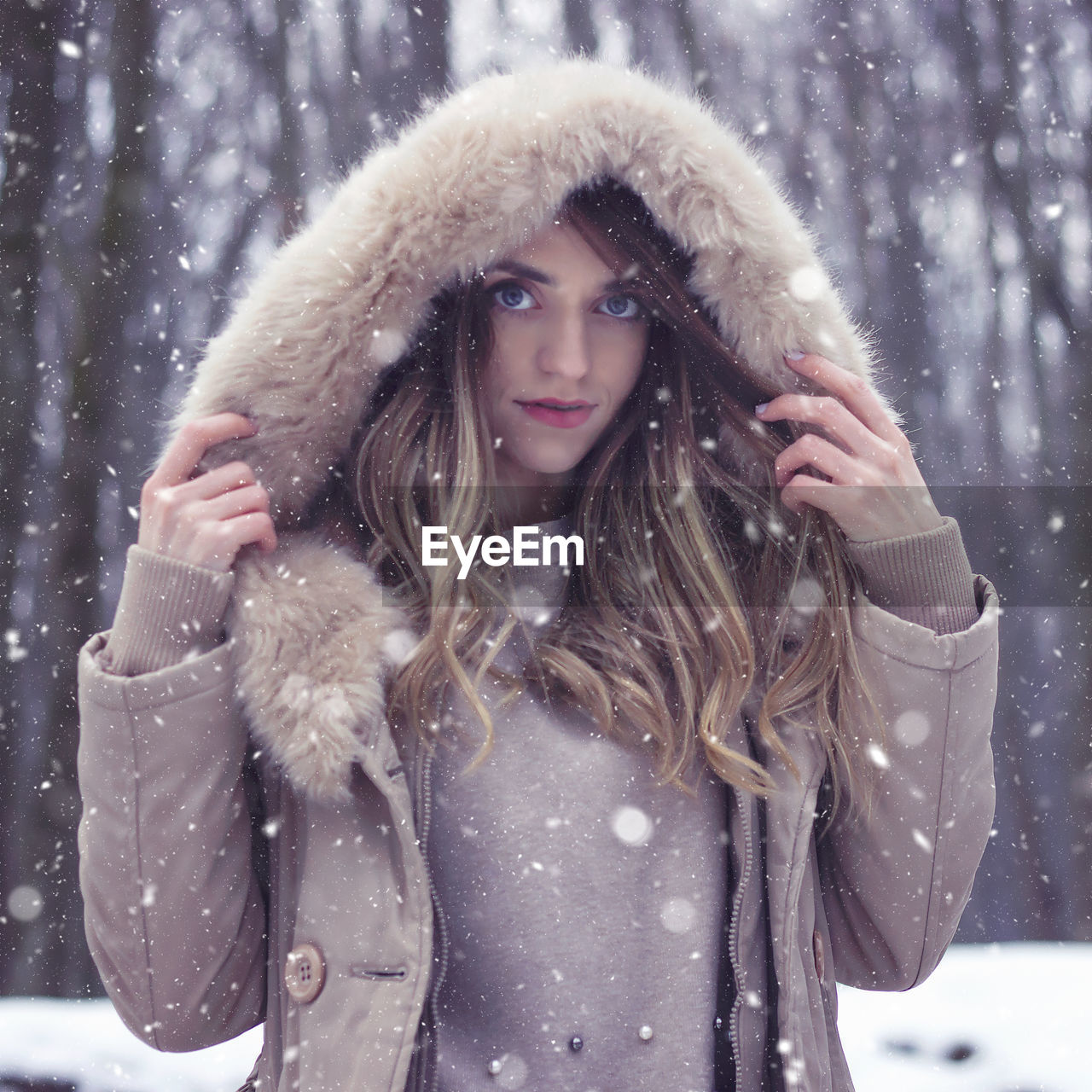 Portrait of young woman wearing warm clothing during winter