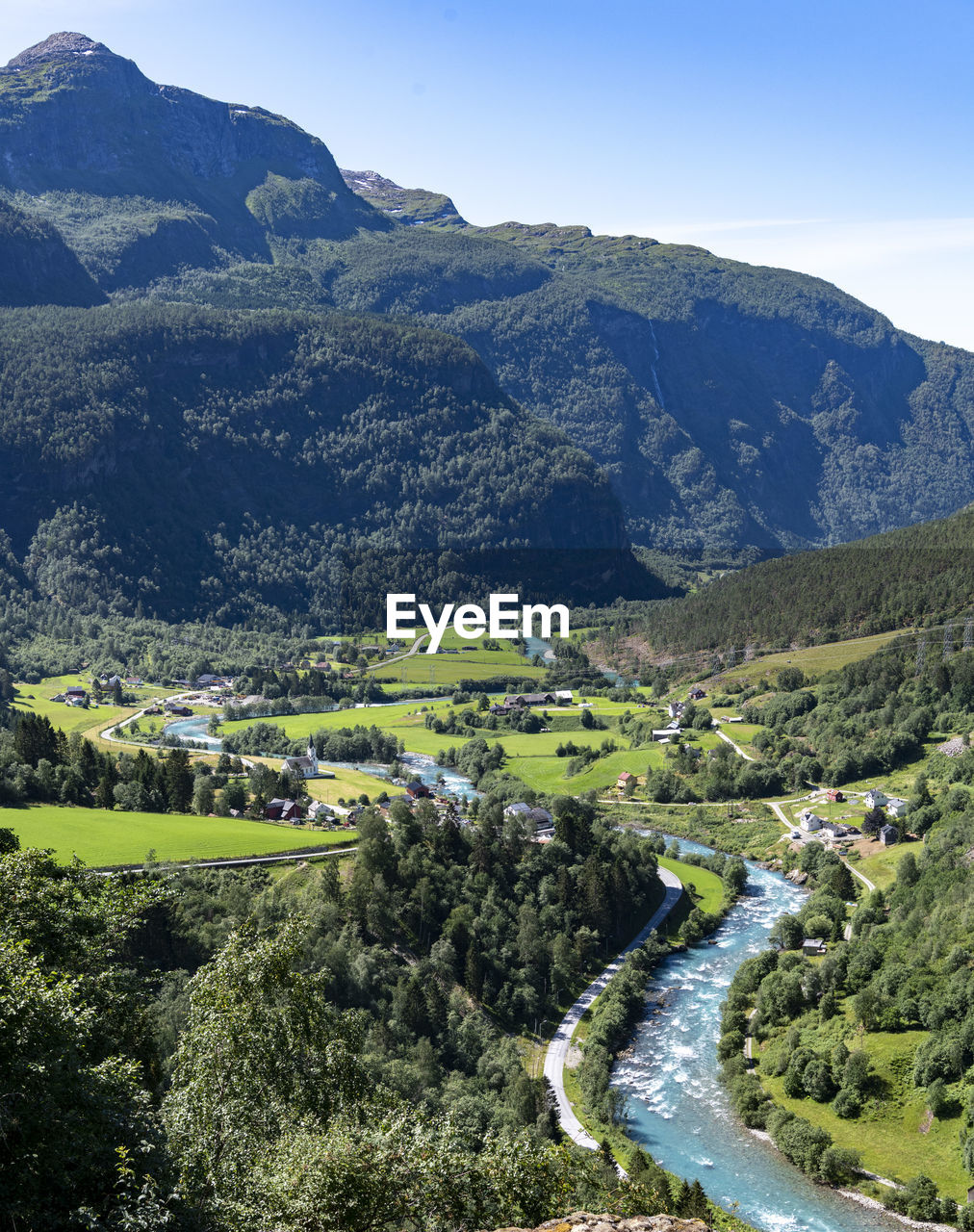mountain, scenics - nature, environment, landscape, plant, beauty in nature, tree, nature, mountain range, land, aerial photography, sky, tranquility, valley, no people, tranquil scene, non-urban scene, mountain pass, green, road, water, day, travel destinations, outdoors, travel, high angle view, forest, idyllic, lake, rural scene, blue, architecture, plateau, transportation, sunlight, rural area, field, clear sky, grass, tourism, building, remote, growth