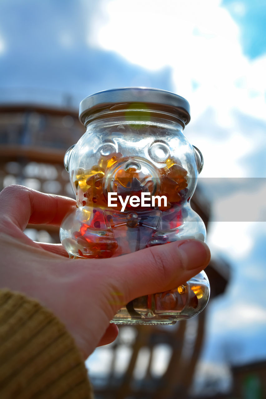 CLOSE-UP OF PERSON HOLDING ICE CREAM IN JAR