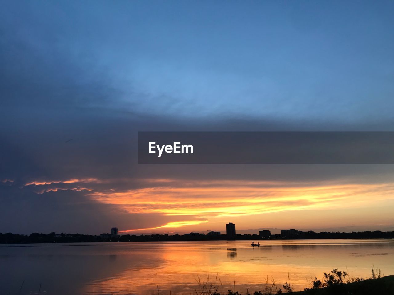 Scenic view of lake against sky during sunset