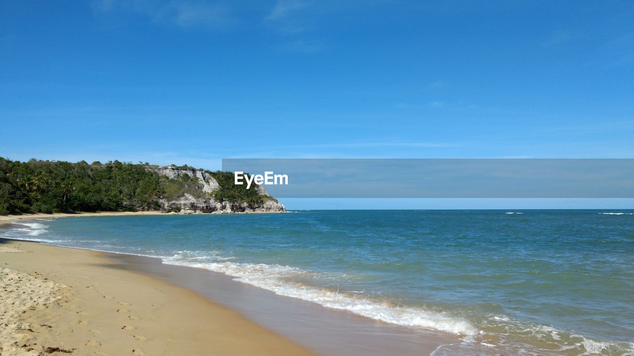 Scenic view of sea against blue sky