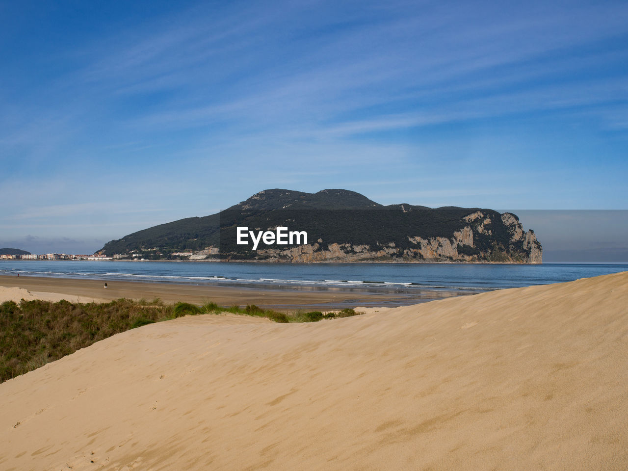 Scenic view of beach against blue sky