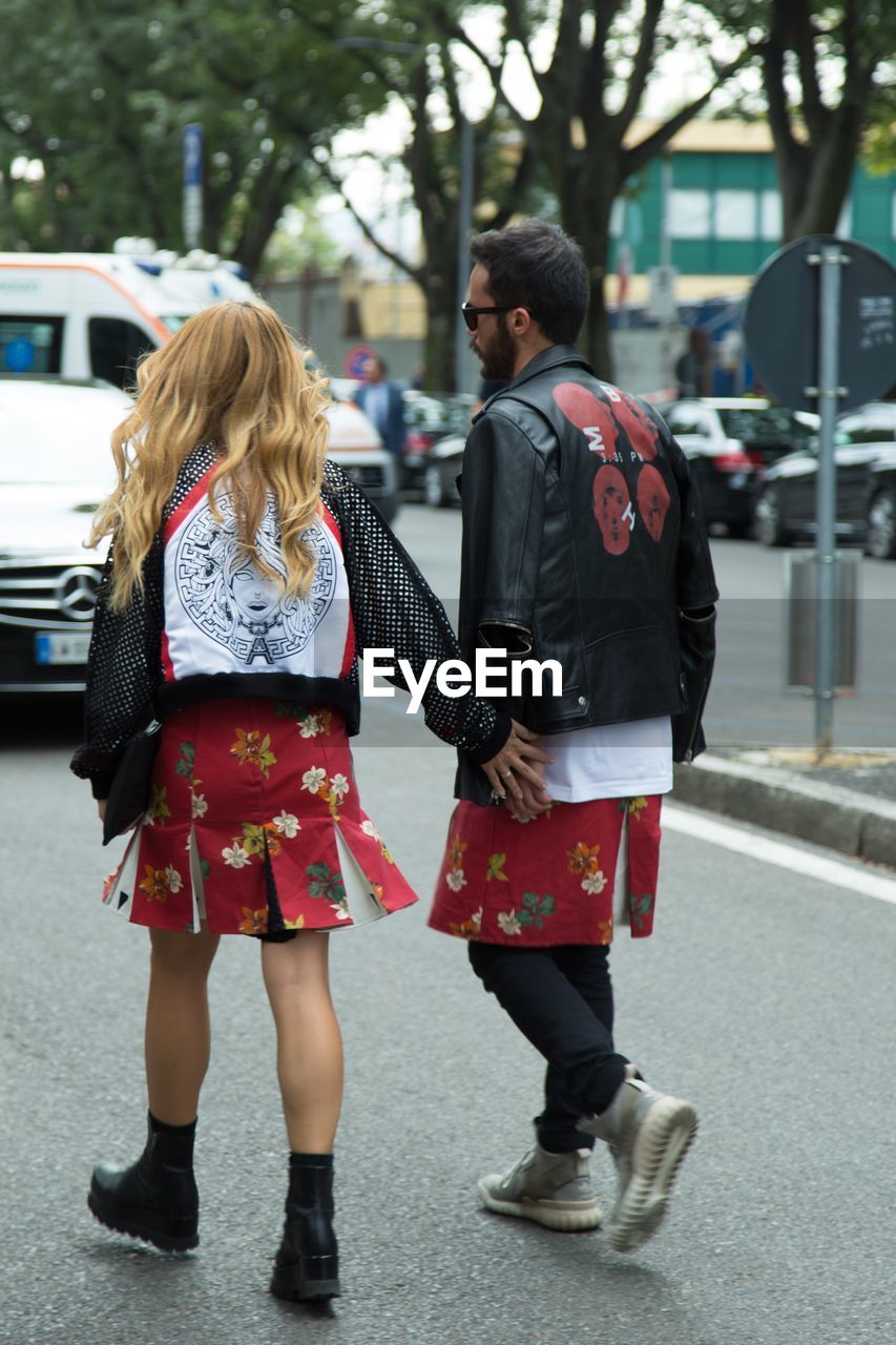 REAR VIEW OF WOMEN WALKING ON STREET