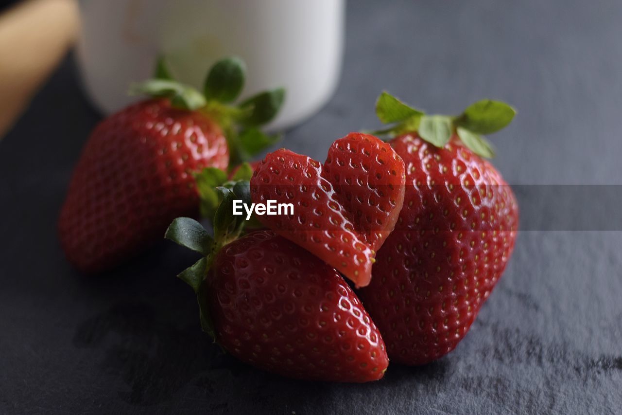 CLOSE-UP OF STRAWBERRIES AND RED BERRIES ON TABLE