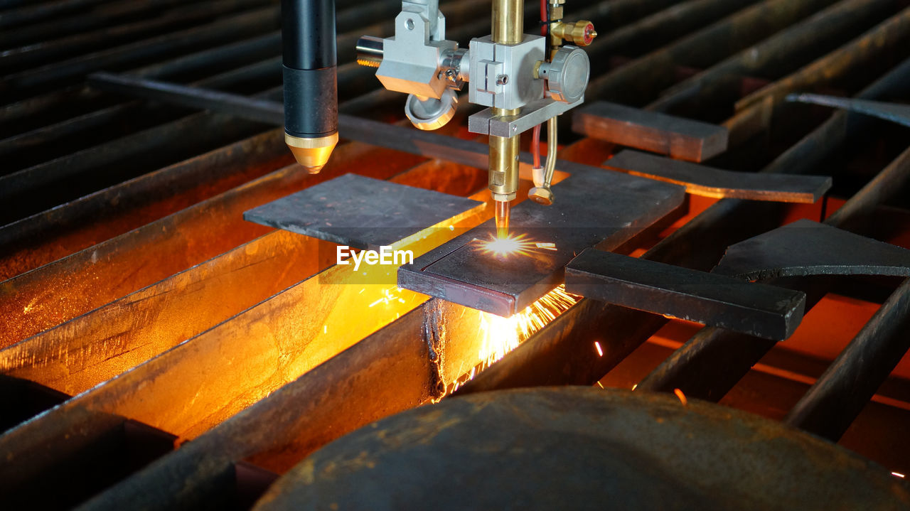 Close-up of machine welding metal at factory