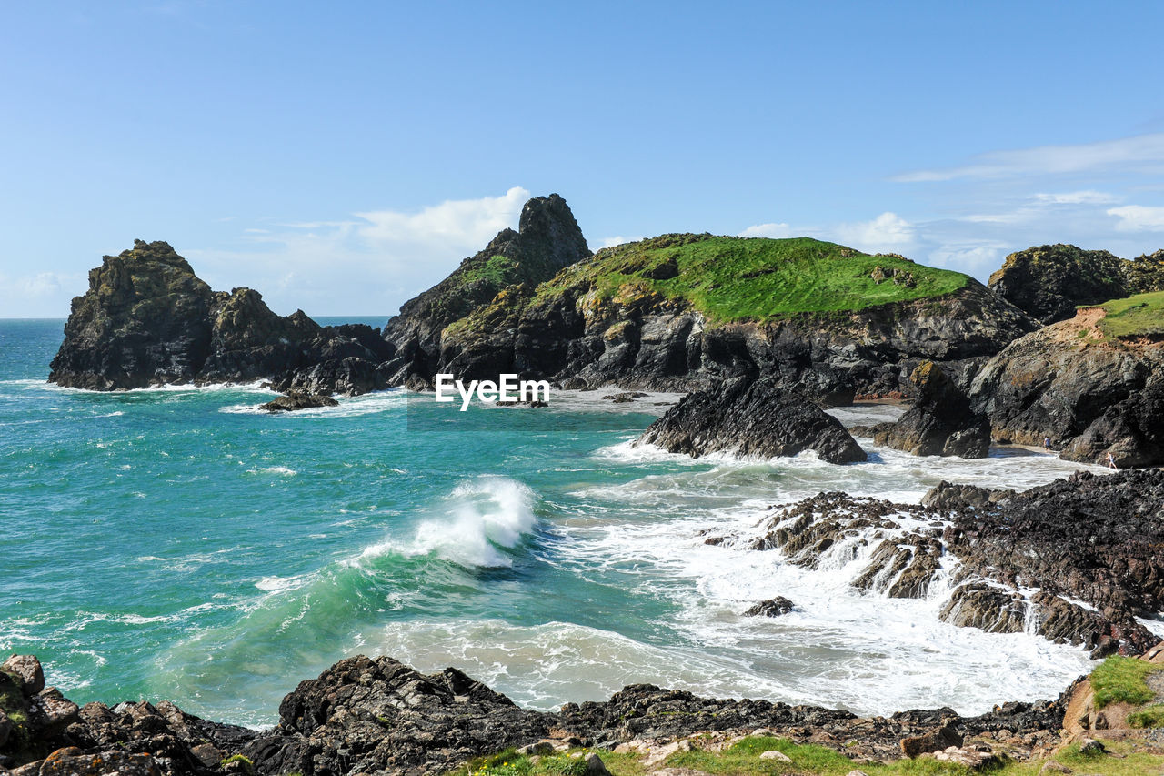 Rock formations in sea against sky