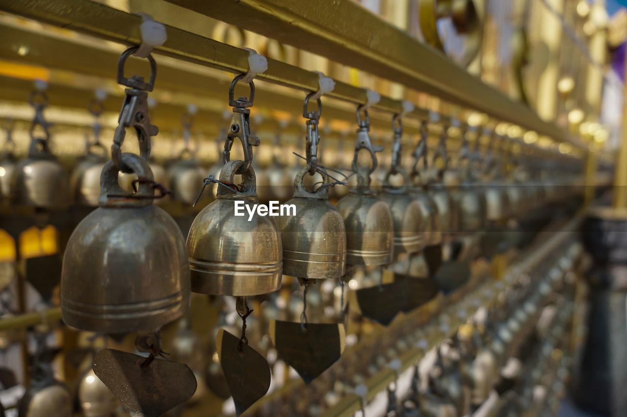 Close-up of small brass bells in the temple
