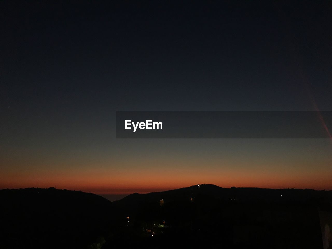 SILHOUETTE MOUNTAINS AGAINST SKY AT NIGHT