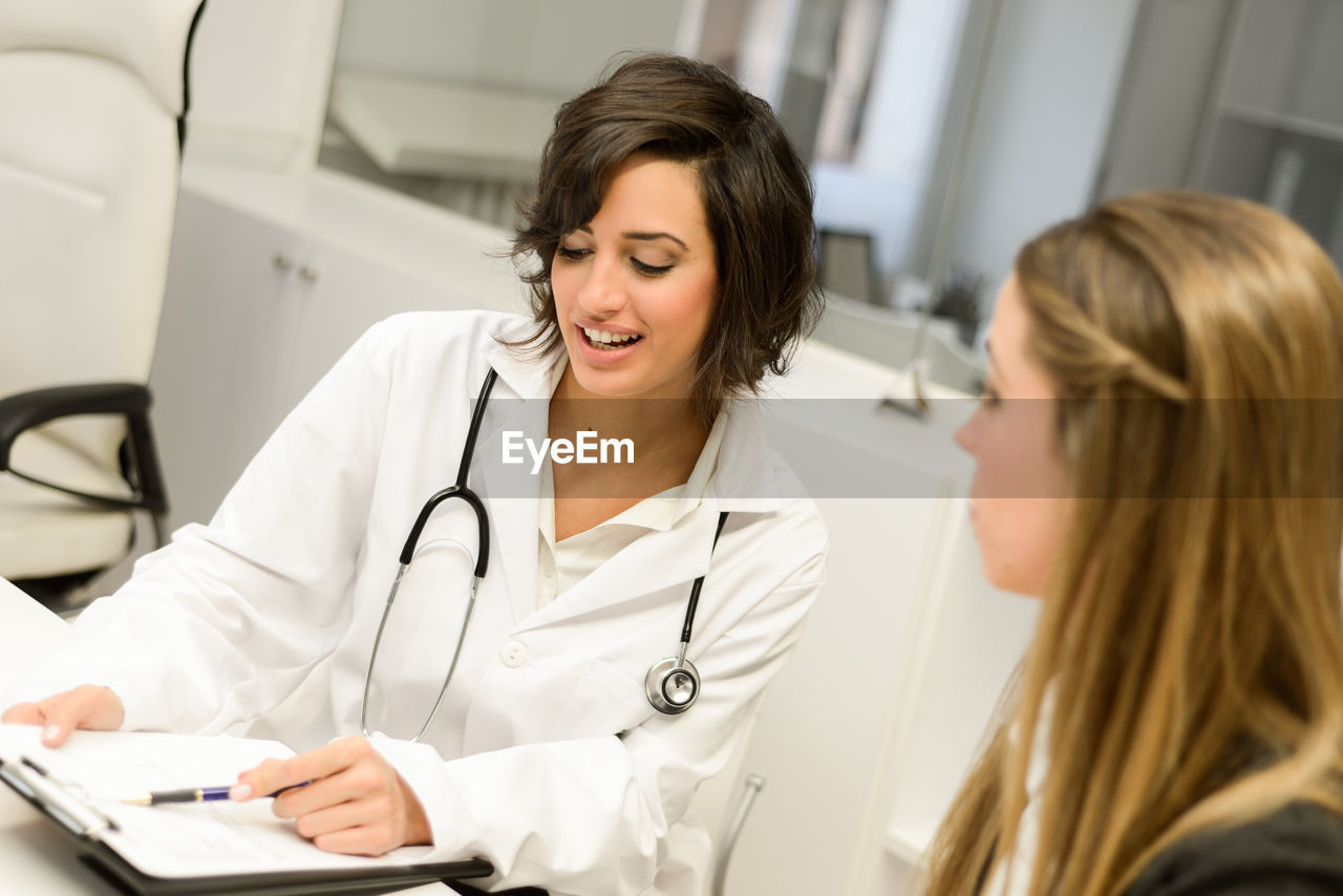 Female doctor discussing with patient at hospital