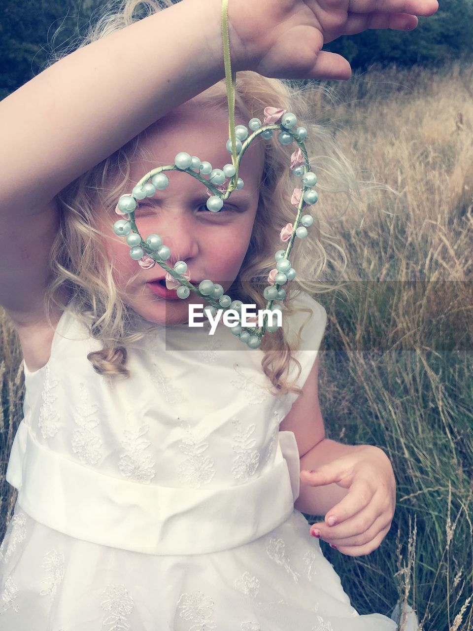 Close-up of cute girl holding heart shape decoration