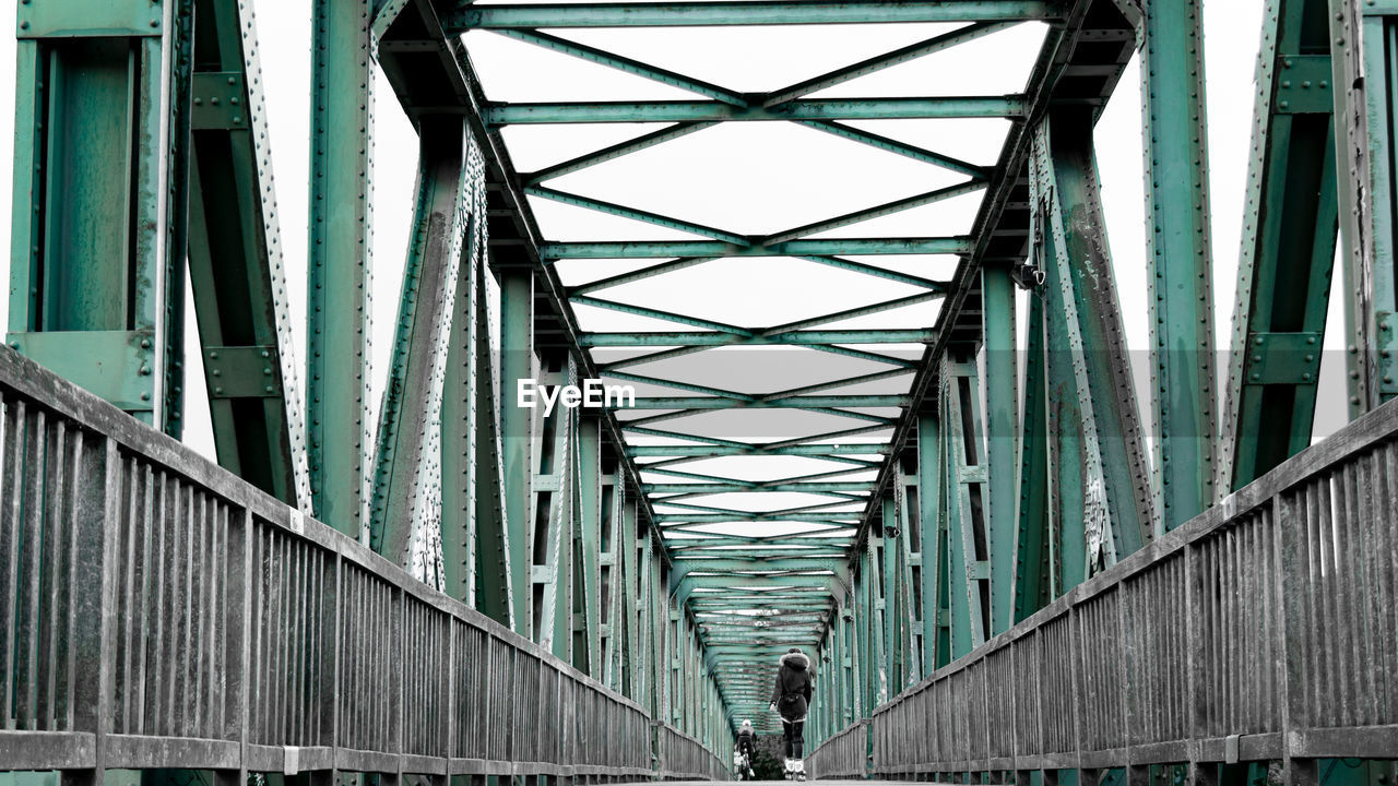 LOW ANGLE VIEW OF BRIDGE OVER BUILDINGS