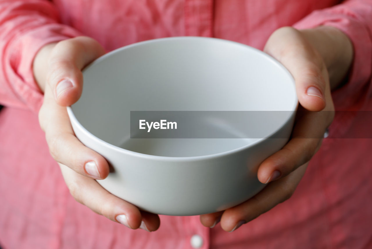 Midsection of woman holding bowl