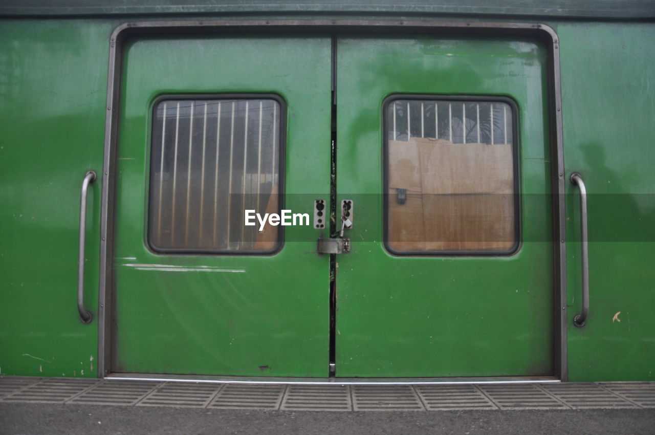 CLOSE-UP OF TRAIN WINDOW ON RAILROAD TRACK