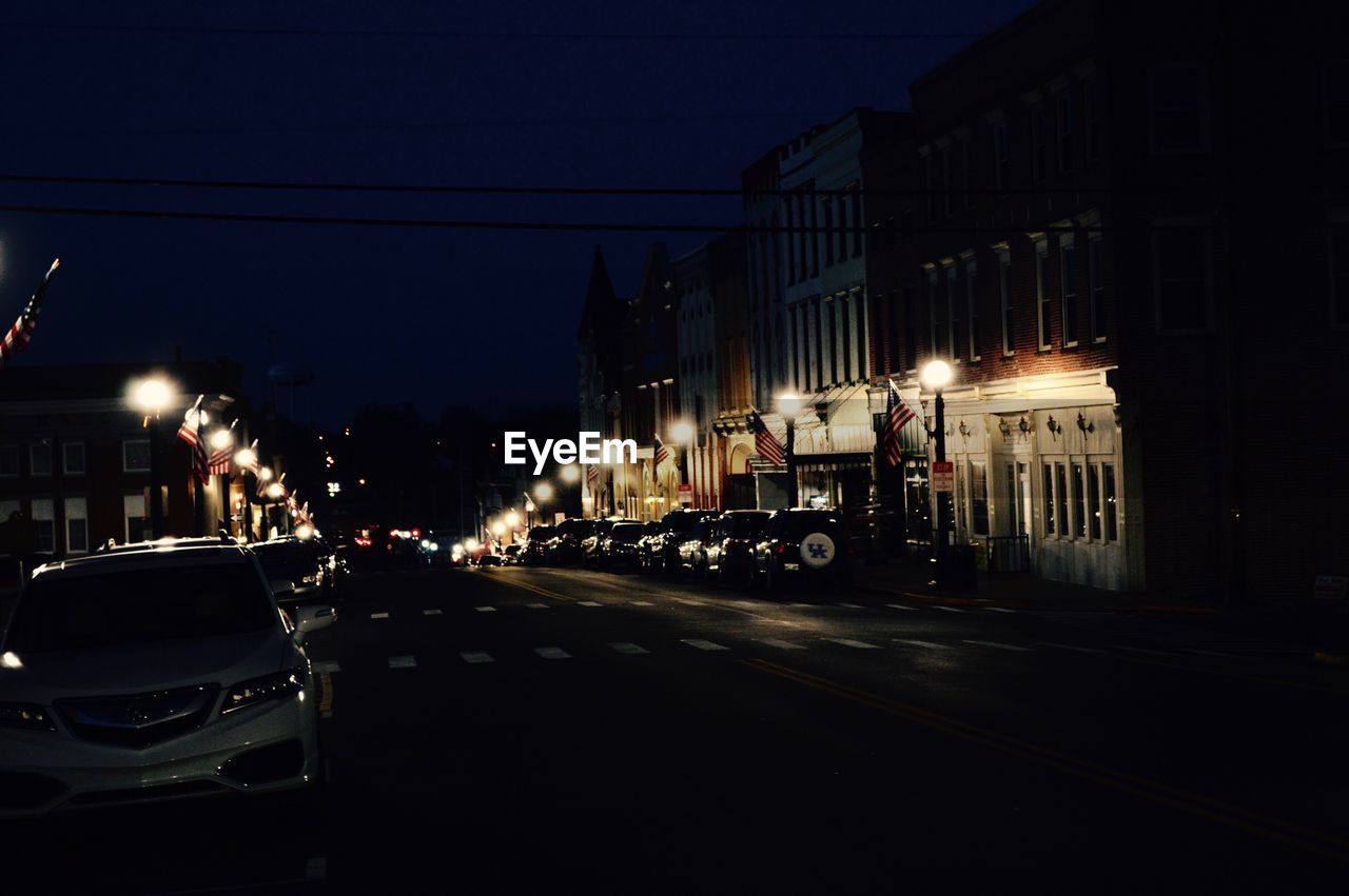 ILLUMINATED CITY STREET AT NIGHT