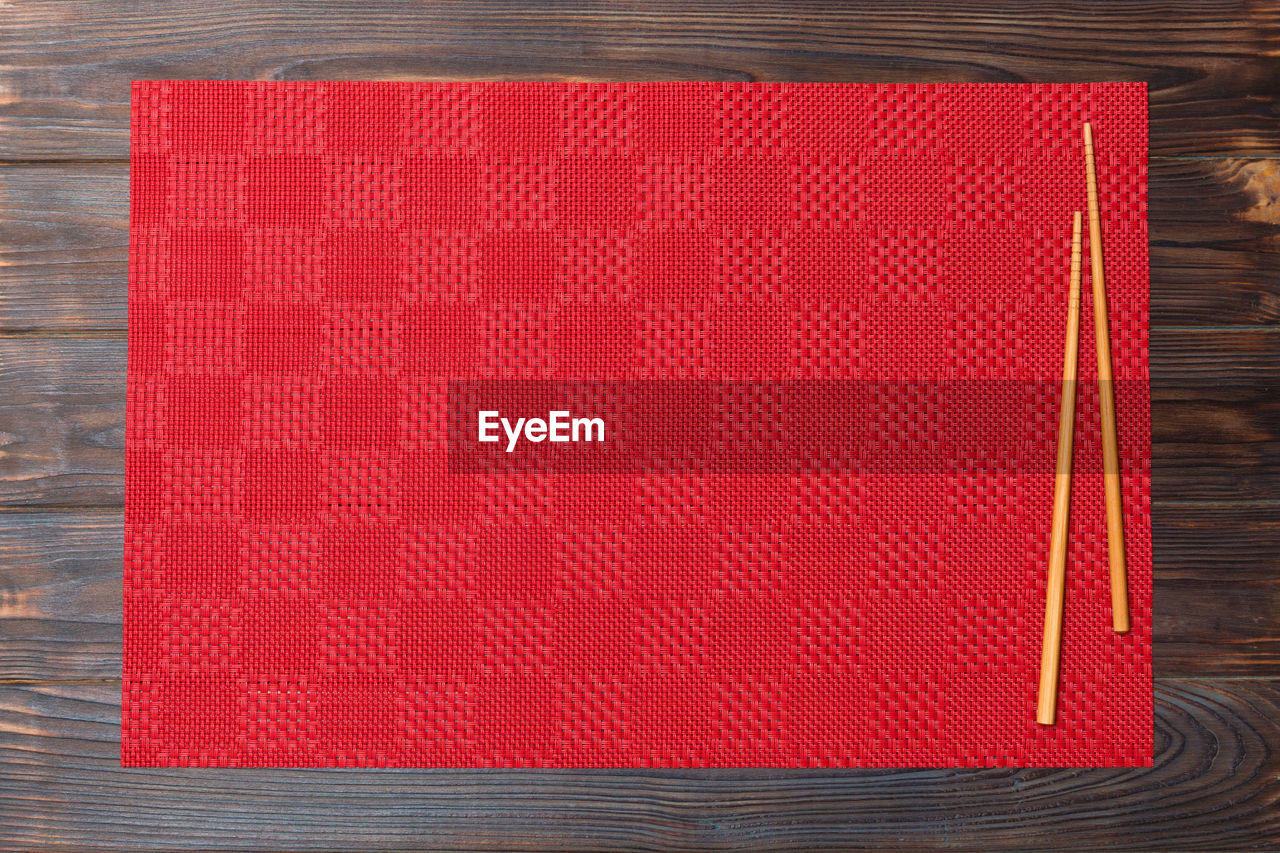 High angle view of red sushi mat on table