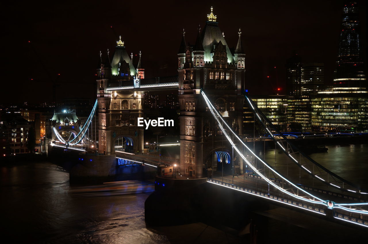 High angle view of tower bridge over river at night in city
