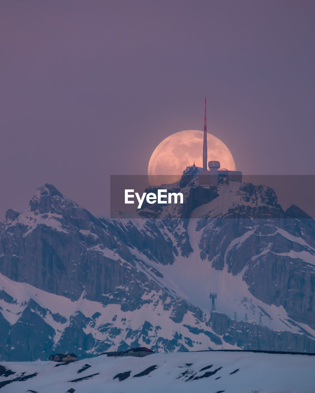 Aerial view of snowcapped mountains against clear sky during winter