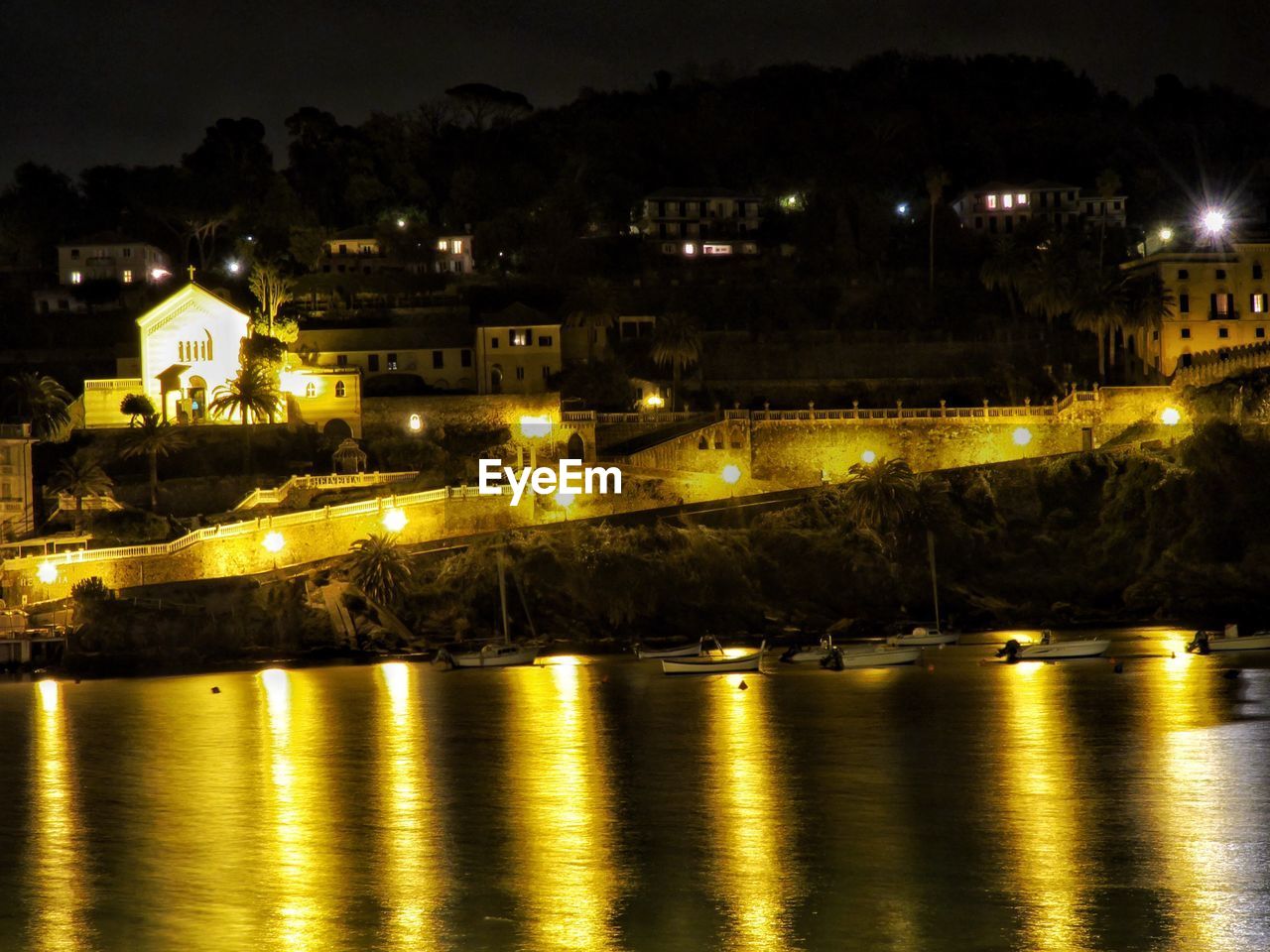 VIEW OF ILLUMINATED CITY AT NIGHT