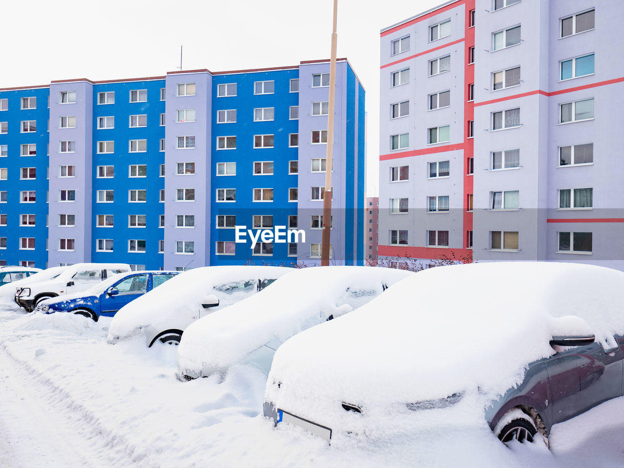 Street blocked by cover of fresh snow since night big snowstorm. cars covered with snow.