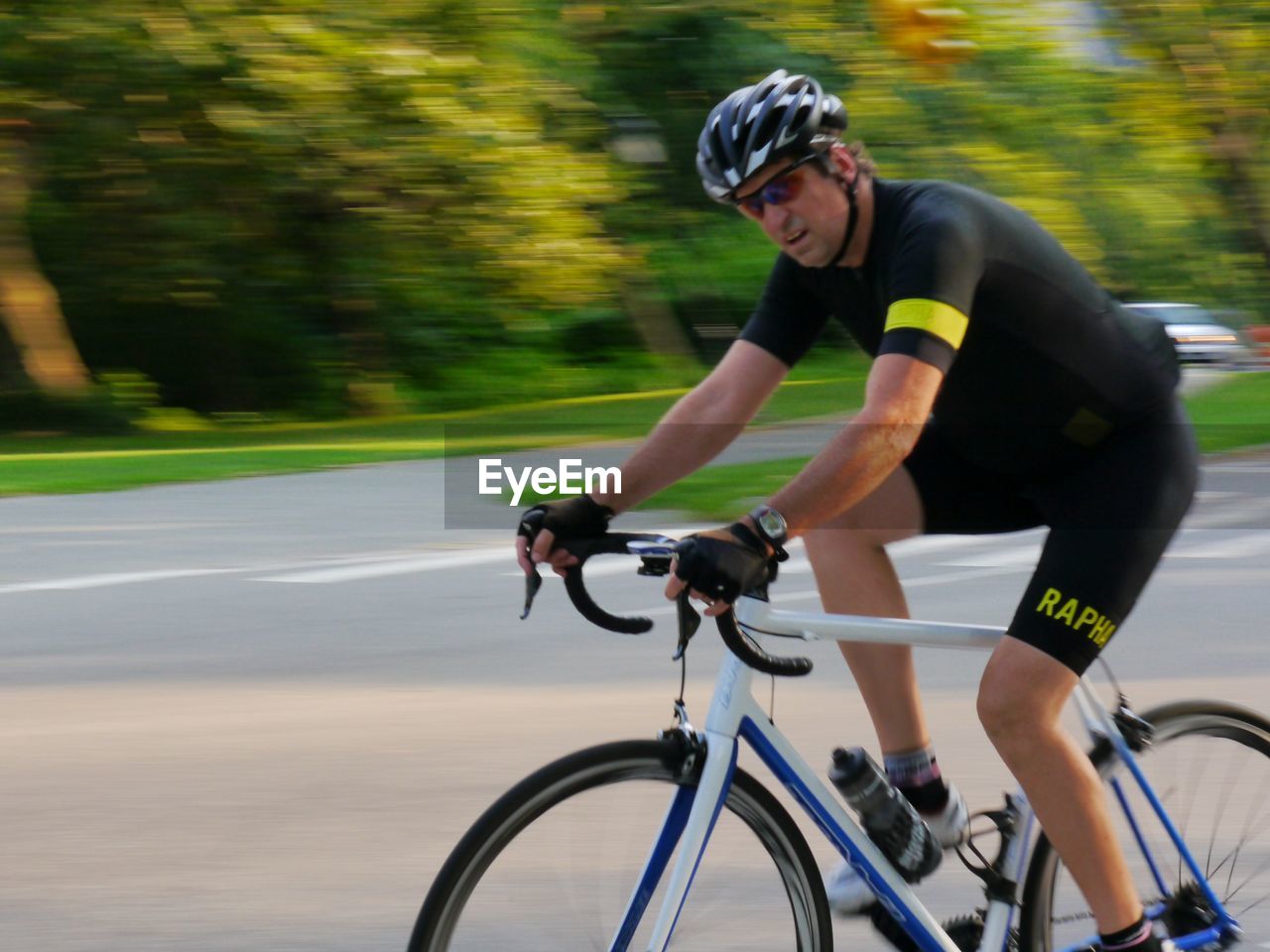 FULL LENGTH OF MAN RIDING BICYCLE ON A BOAT