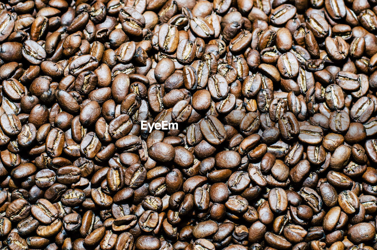 FULL FRAME SHOT OF COFFEE BEANS IN BACKGROUND