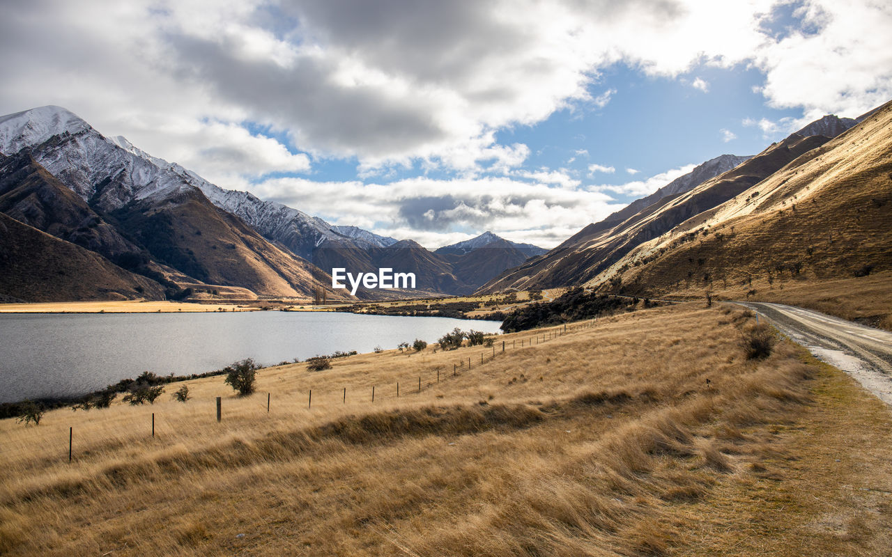 Scenic view of lake and mountains against sky