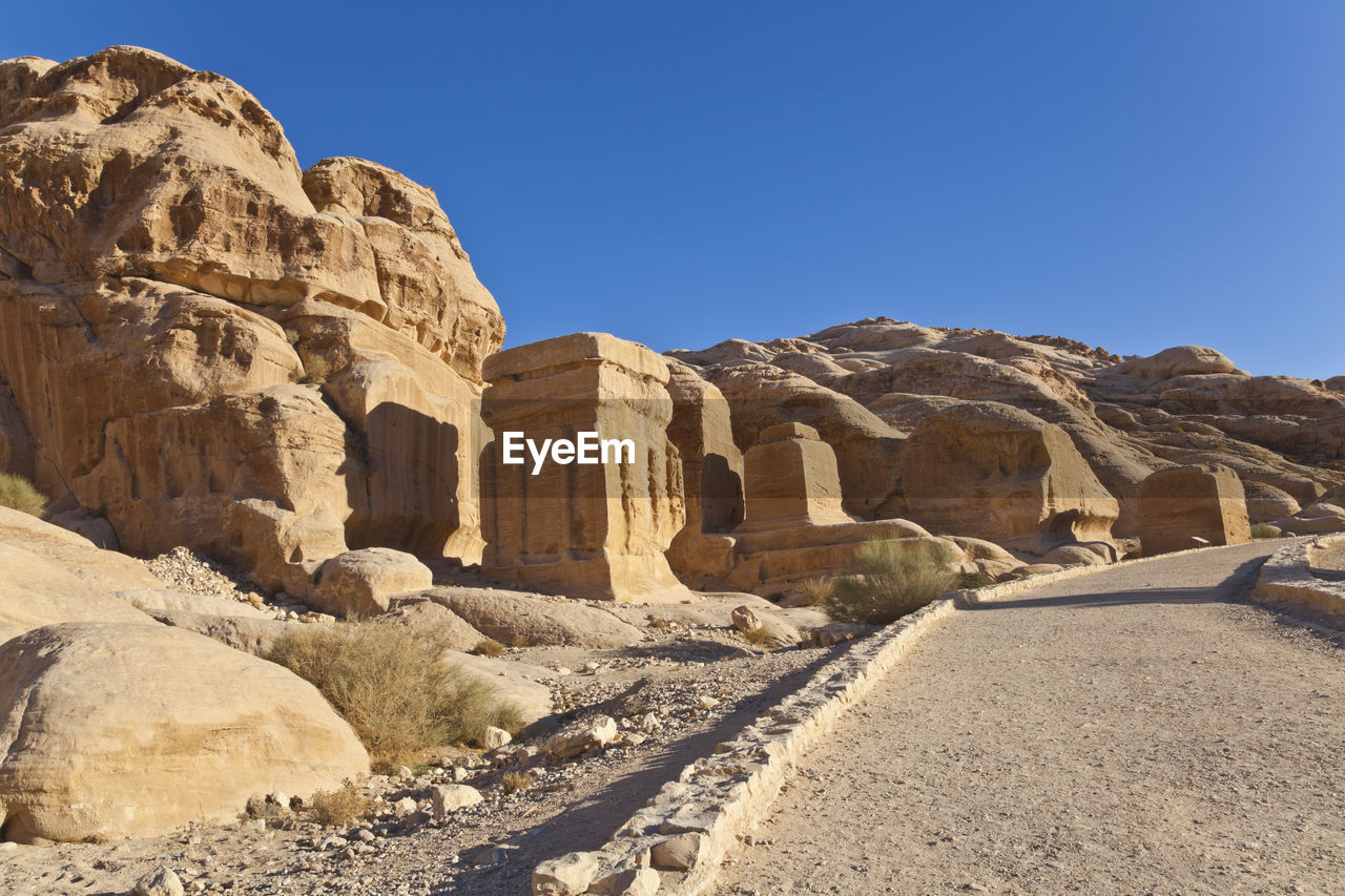 Scenic view of monuments against blue sky