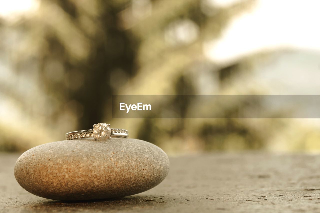 Close-up of engagement ring on table with rock 